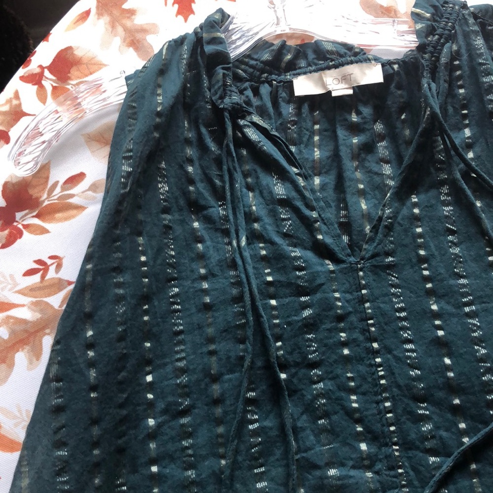Green and gold striped sleeveless shirt